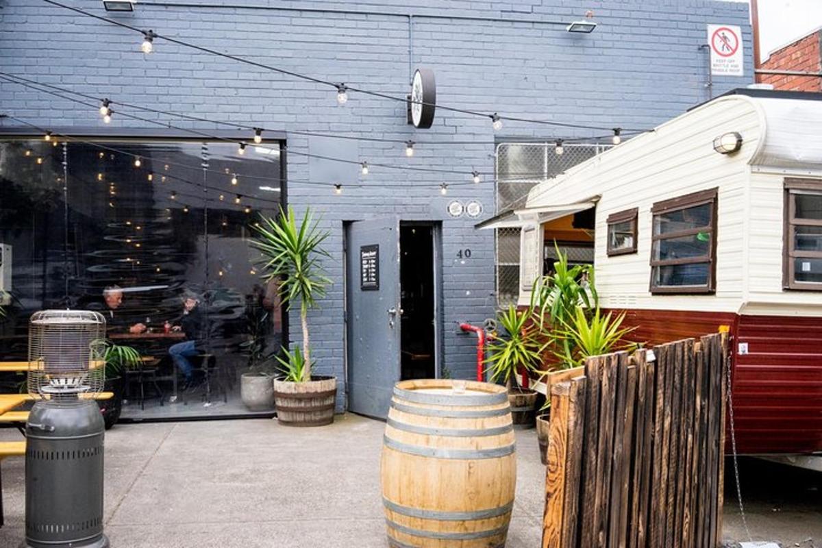 a restaurant with a barrel in front of a building