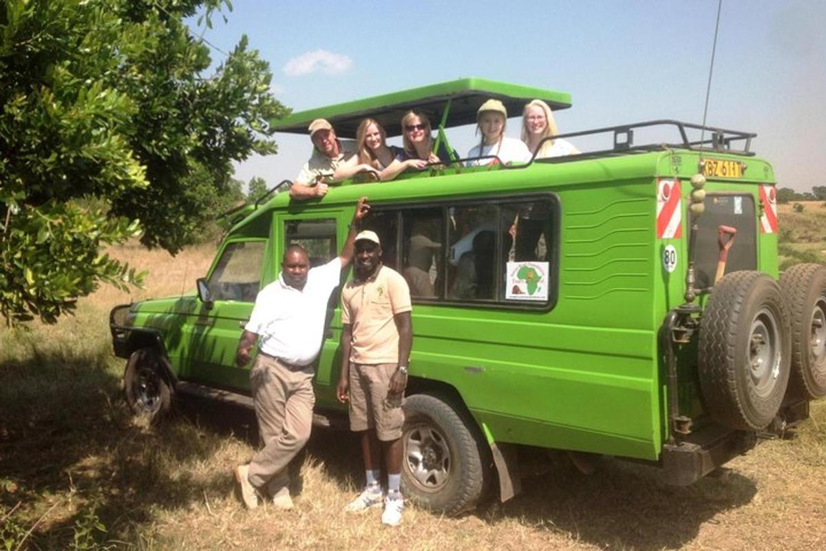 a group of people standing in front of a green van