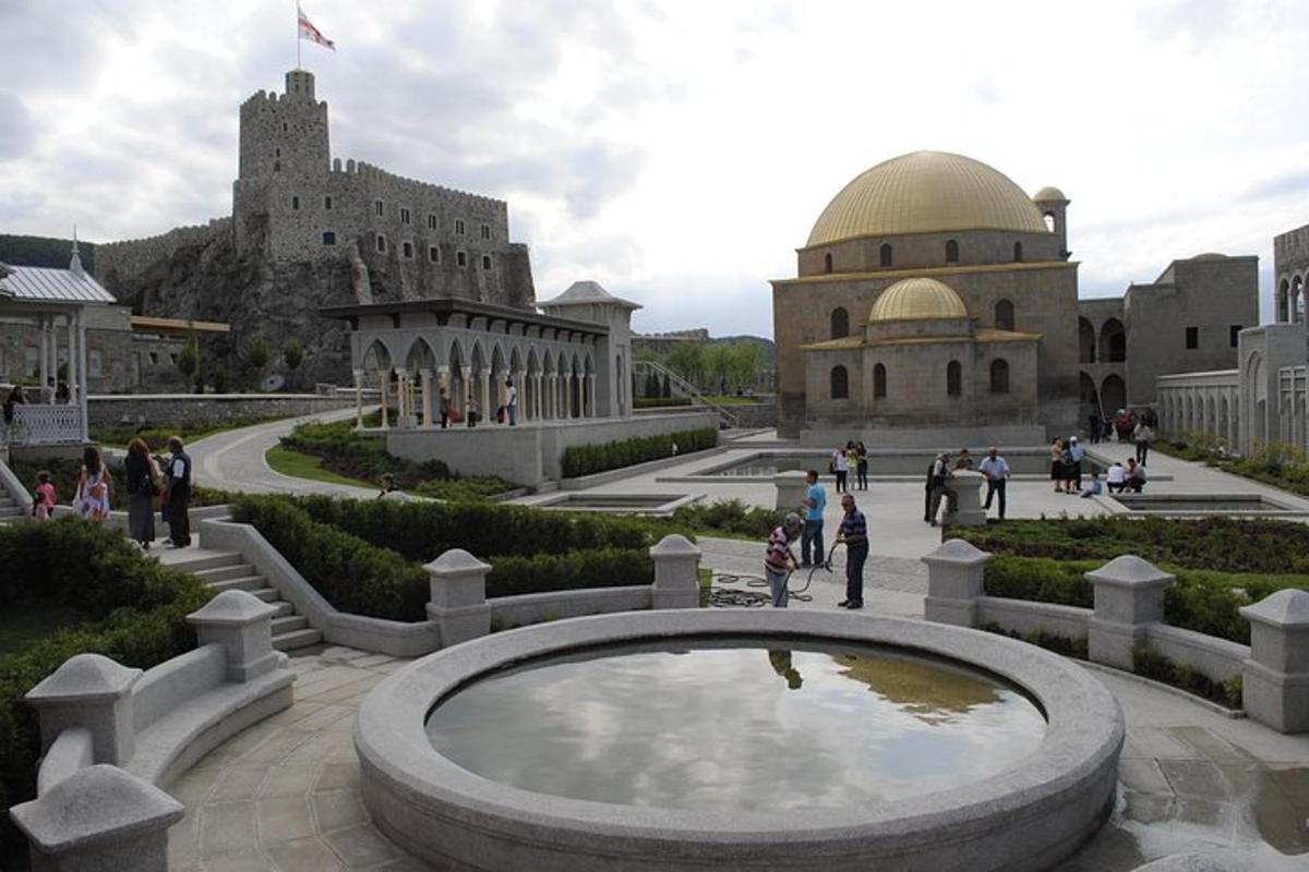 a large fountain in a courtyard with a building
