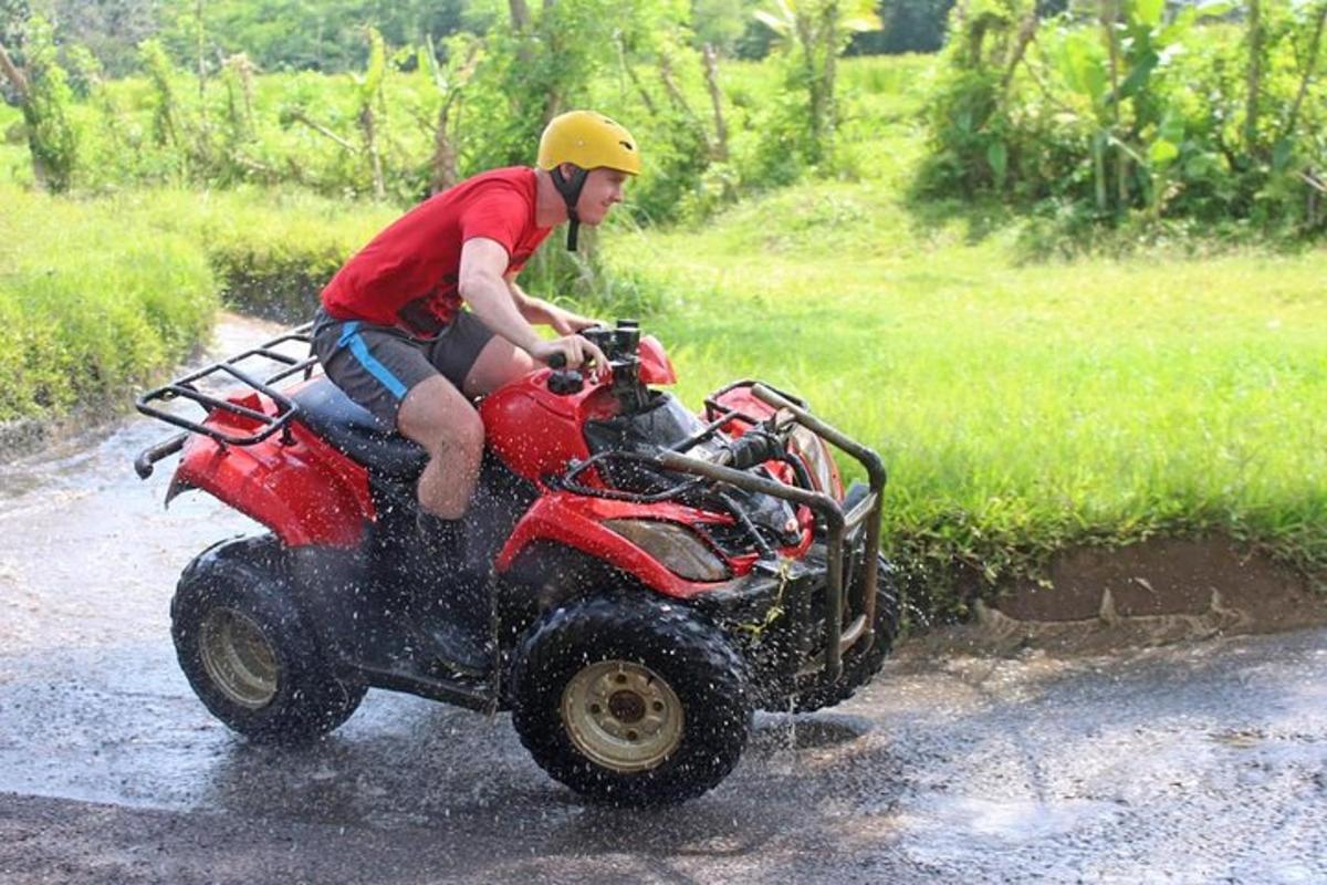 a man riding a four wheeler in the mud