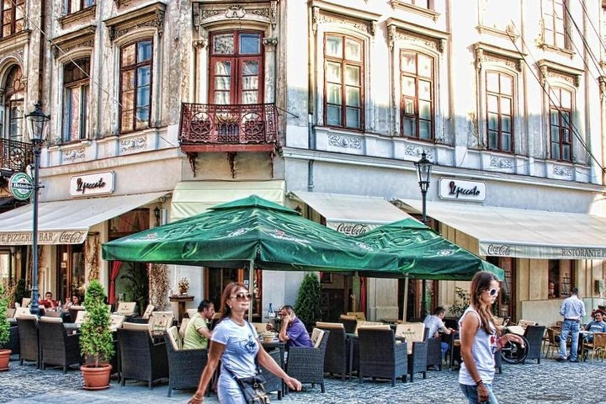 two women walking down a street with a green umbrella