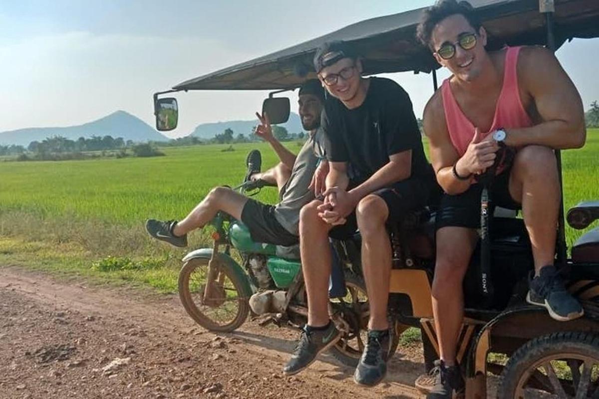 sekumpulan tiga lelaki duduk di atas motosikal di atas jalan tanah