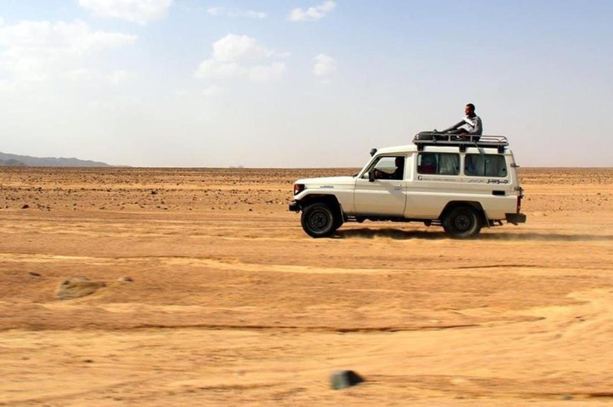 una jeep nel deserto con un uomo sopra