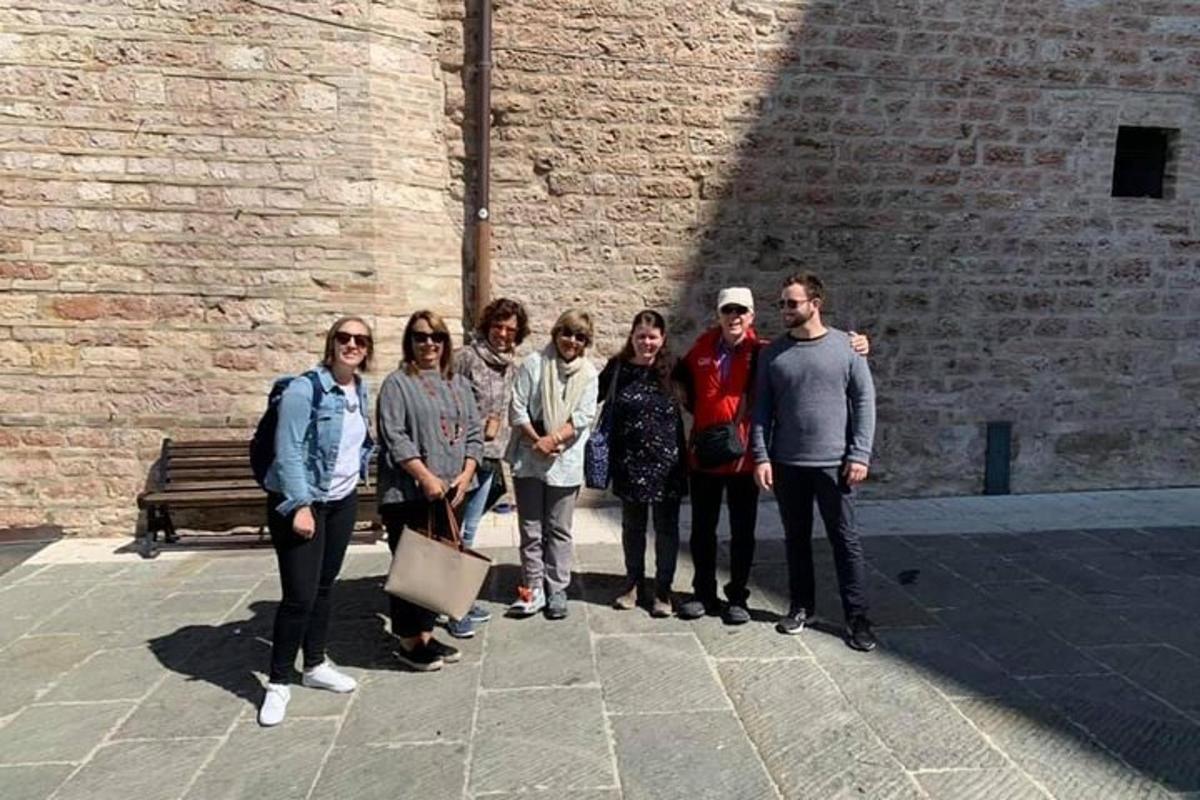 a group of people standing in front of a brick wall