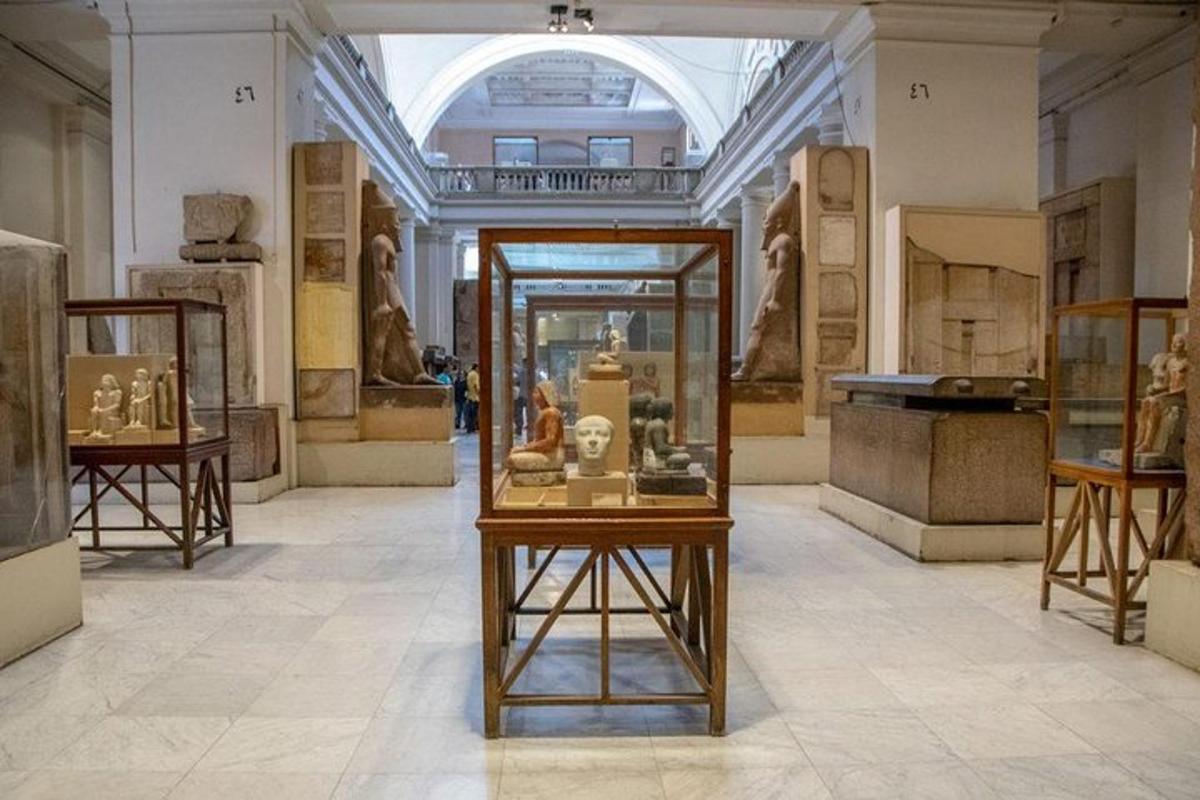 a museum with artifacts in a glass case in a room