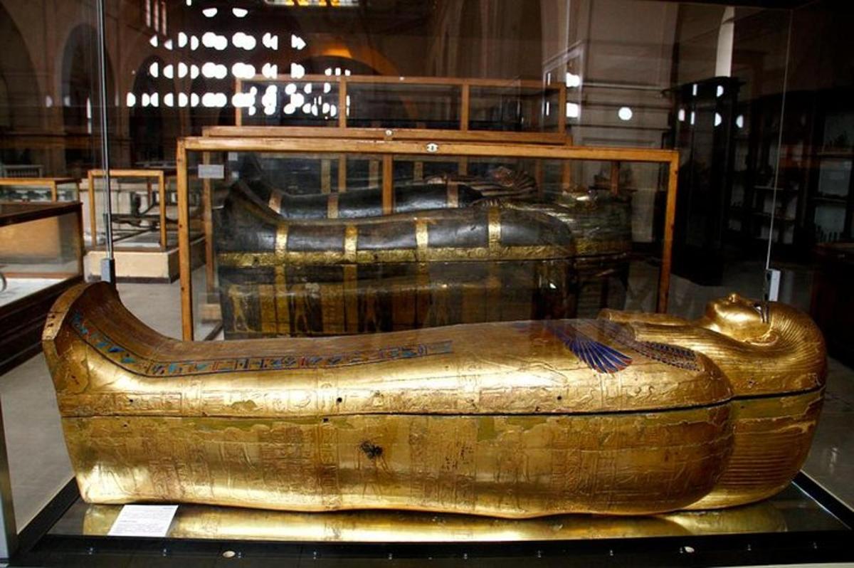 a large gold boat sitting on display in a museum