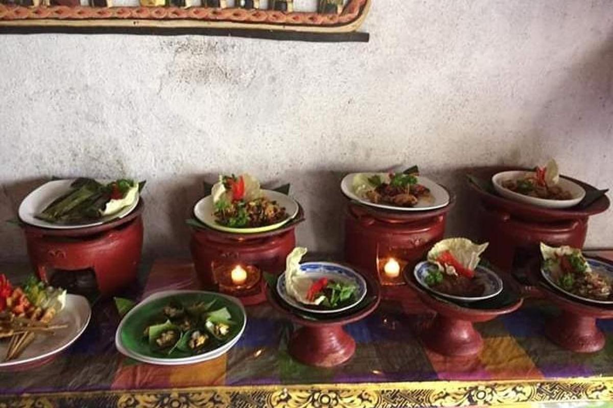 a group of plates of food on a table with candles