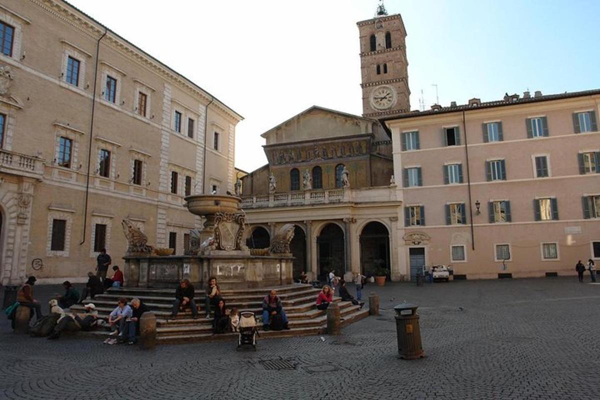 a group of people sitting around a building with a clock tower