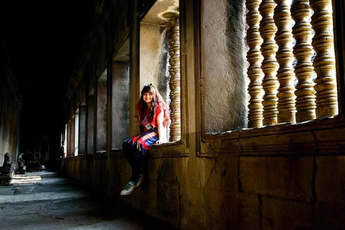a woman sitting on the side of a building