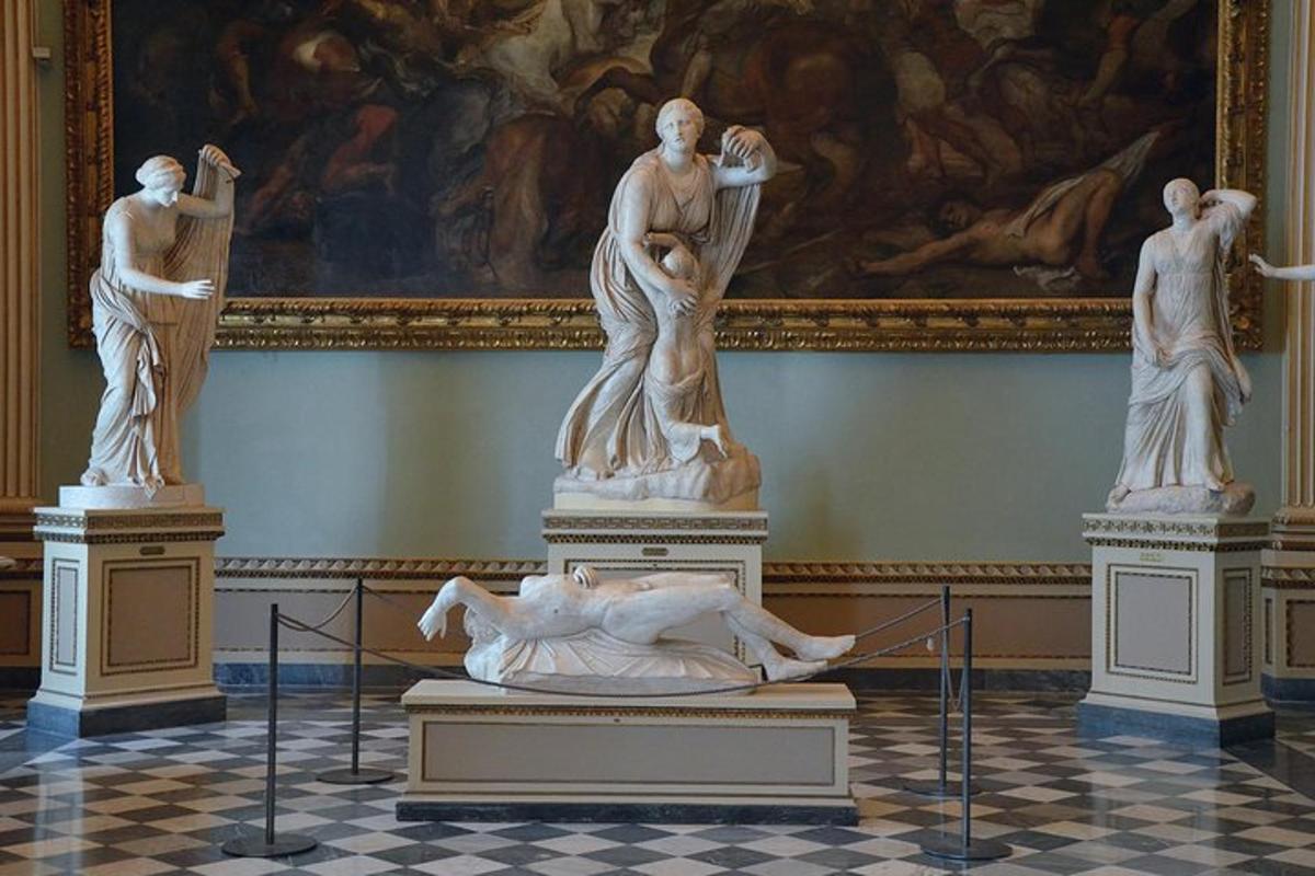 a group of statues on display in a museum