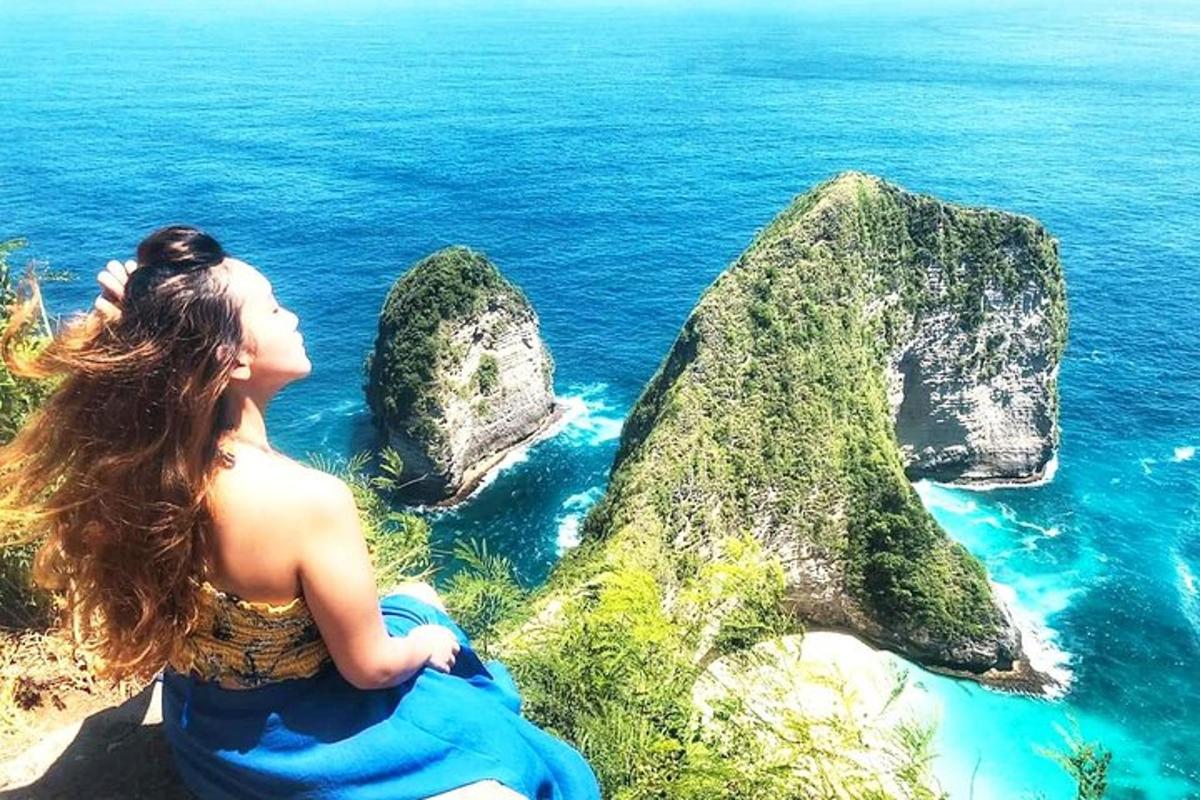 ženska, ki sedi na pečini in gleda na ocean