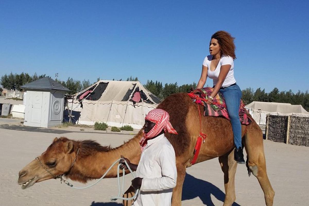 a woman riding on the back of a camel