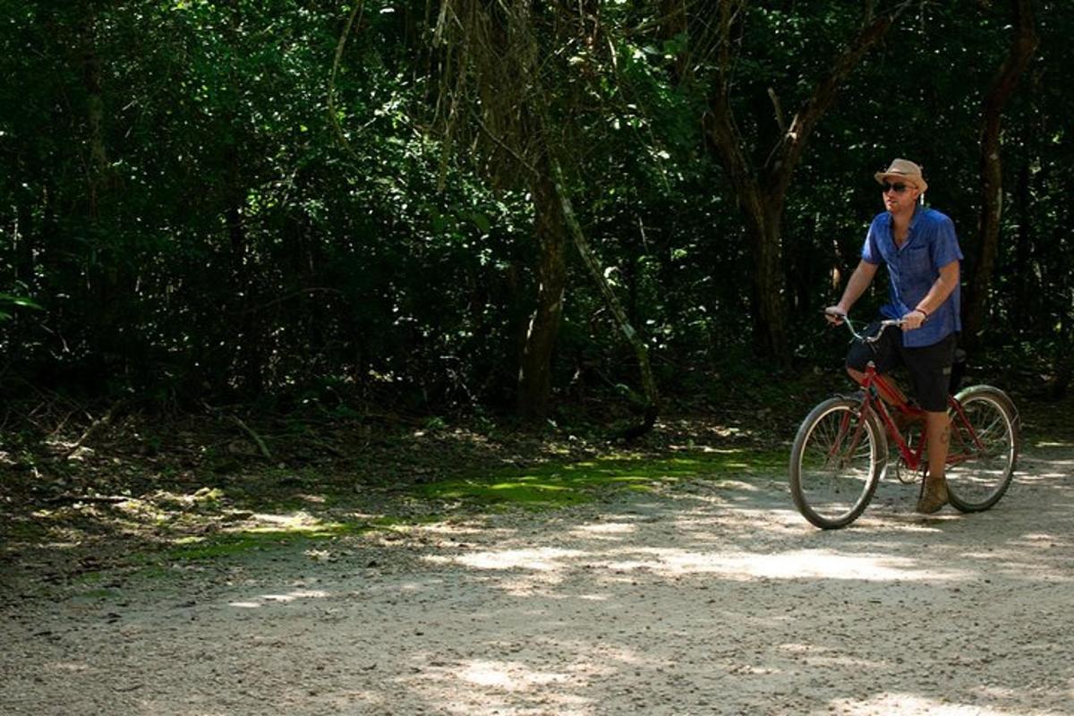 a man riding a bike on a dirt road