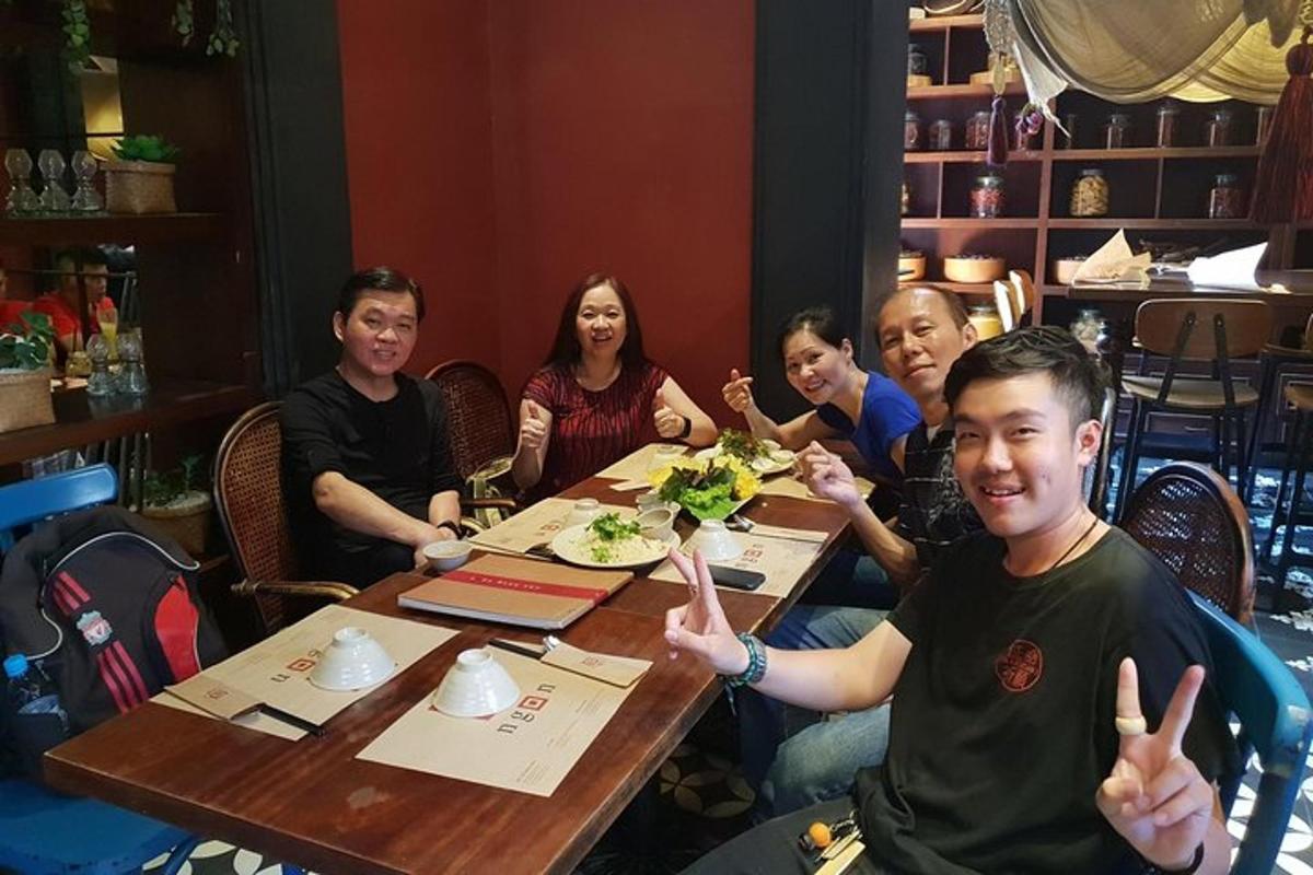 a group of people sitting at a table eating food