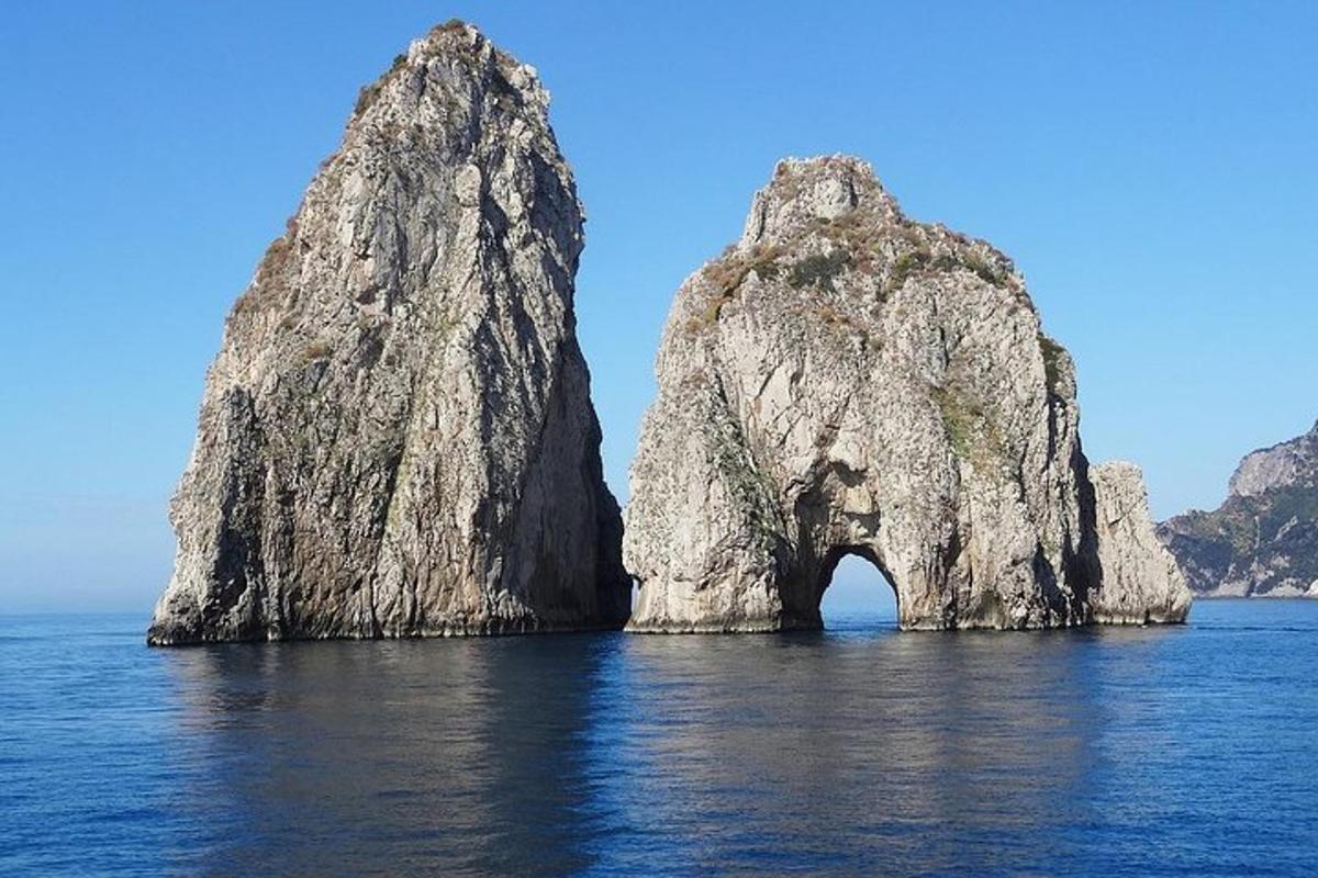 a large rock formation in the water near the ocean