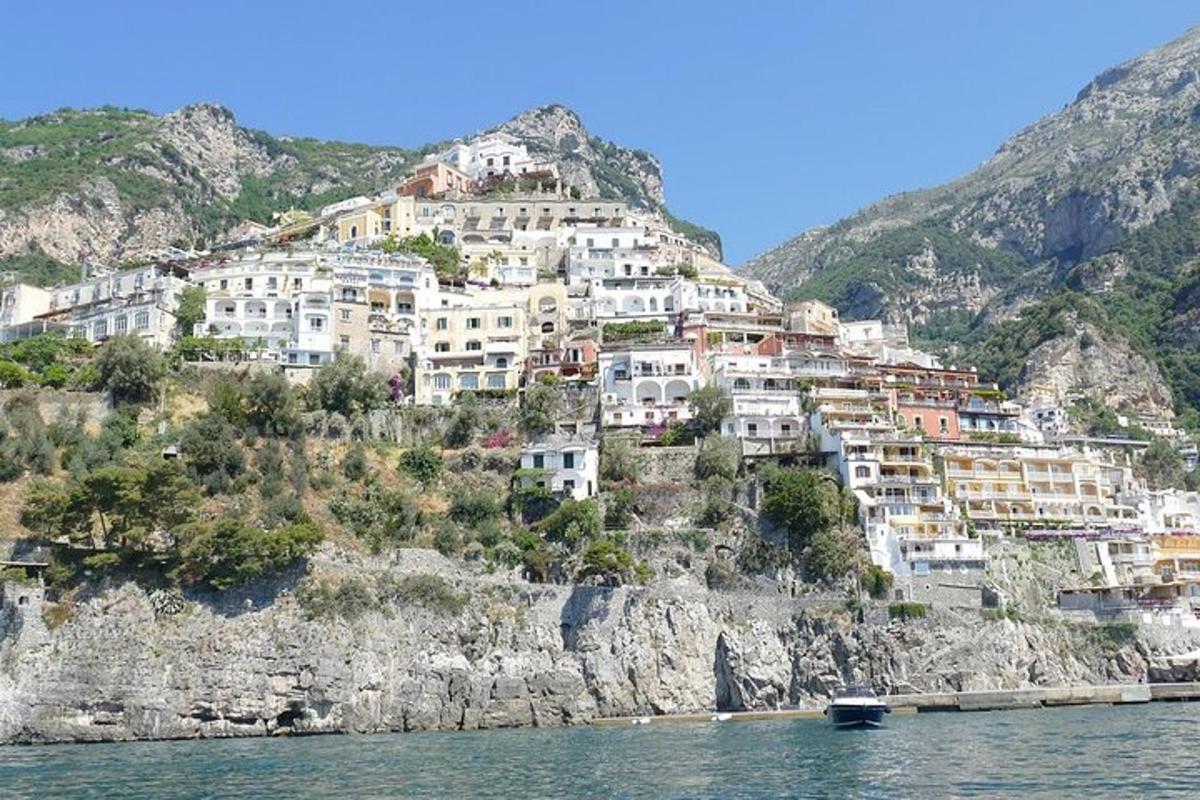 a group of houses on a mountain next to the water