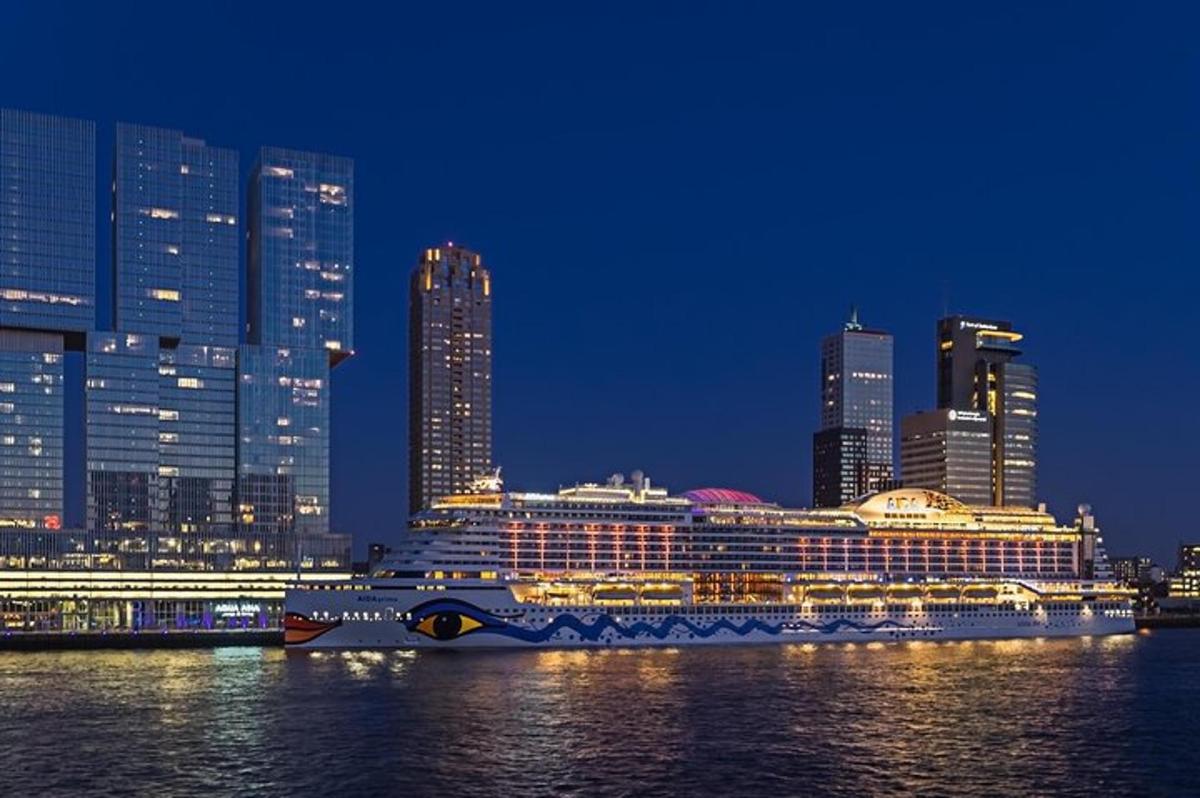a large cruise ship on the water in front of a city