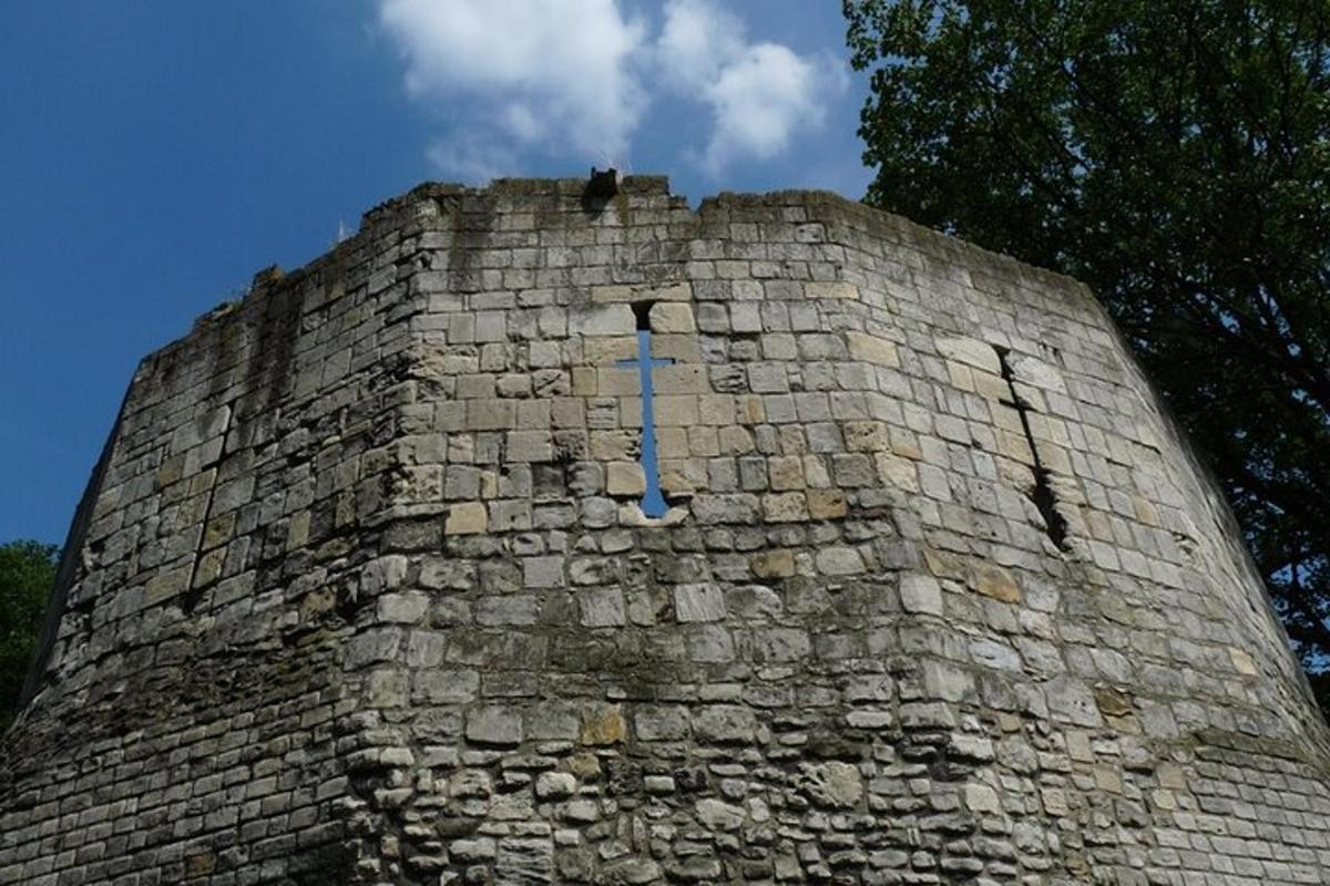 a tall brick wall with a clock on it