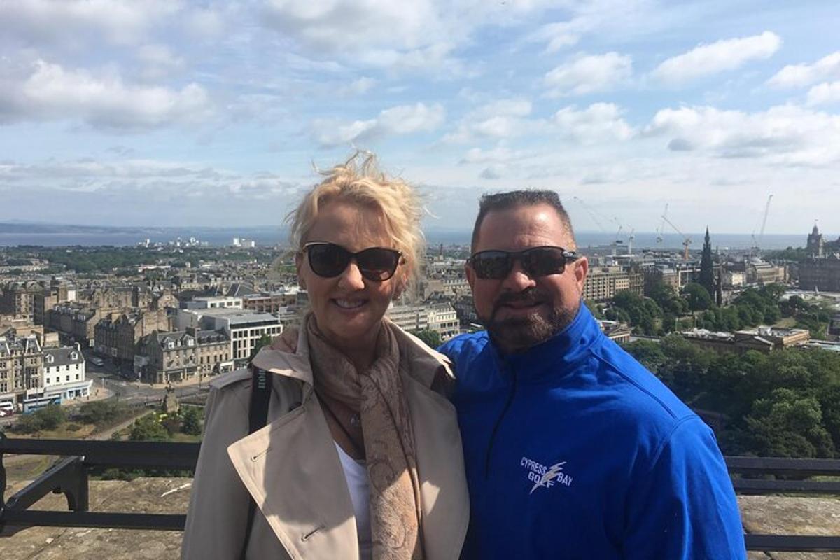 a man and woman standing on top of a city