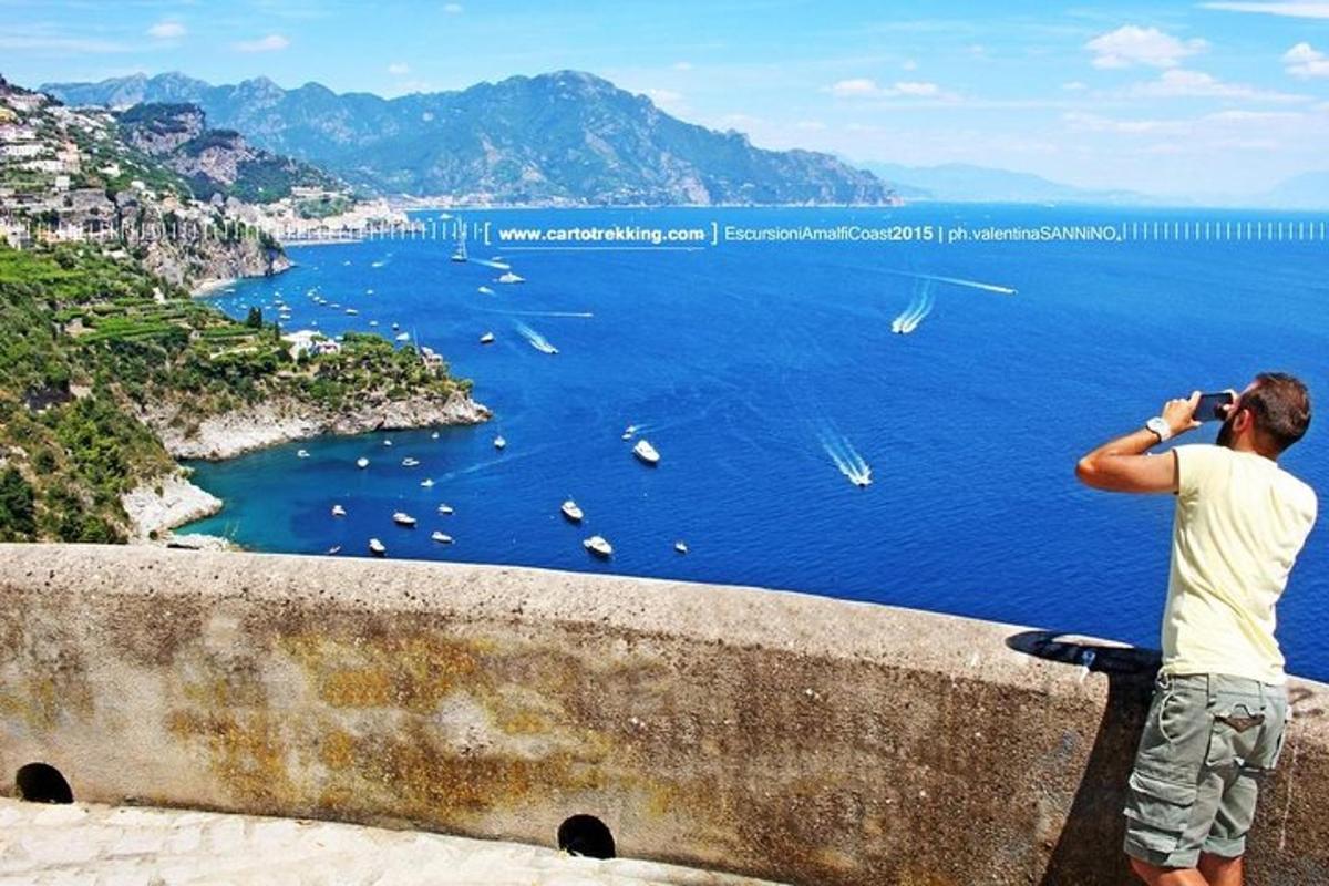 a man taking a picture of the ocean