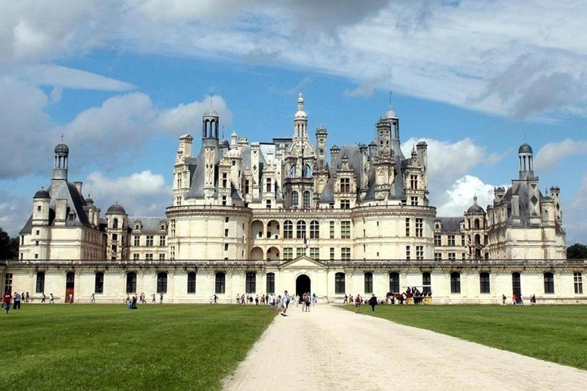 a large white building with people walking in front of it