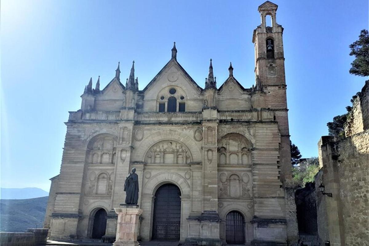 an old church with a statue in front of it