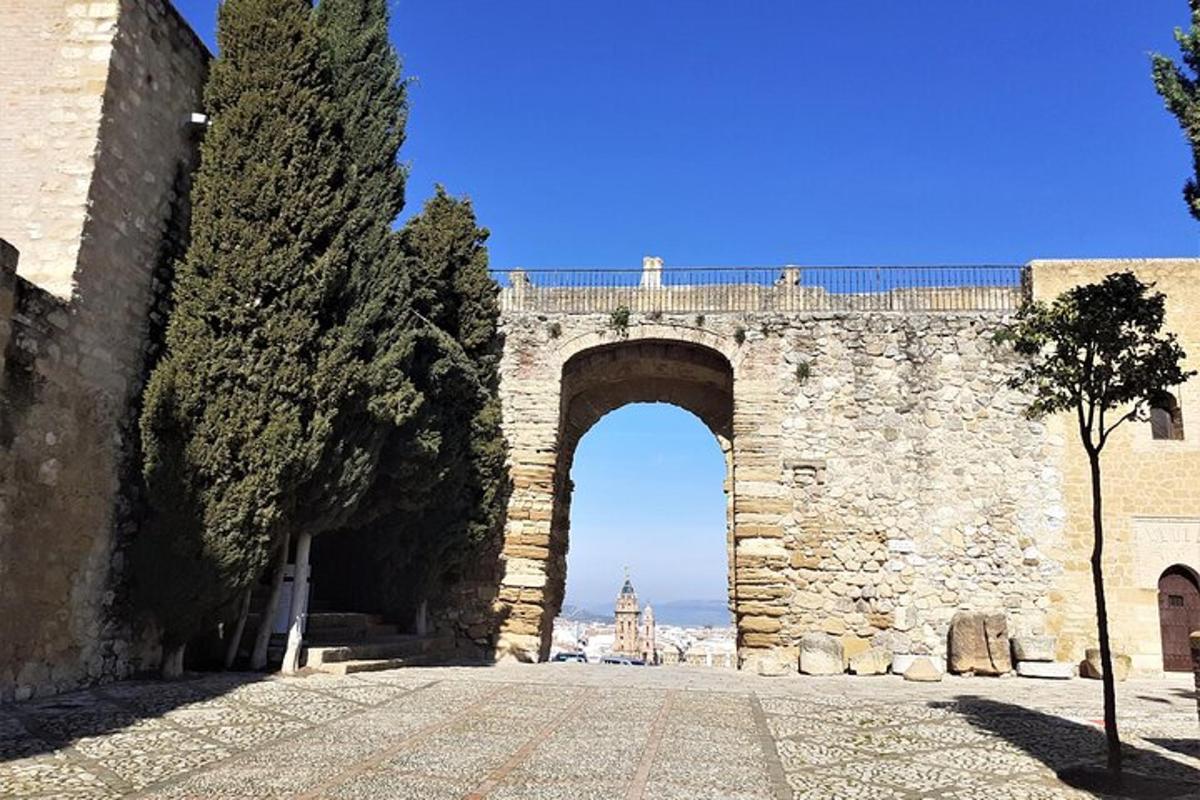 an old stone bridge with an arch over a street