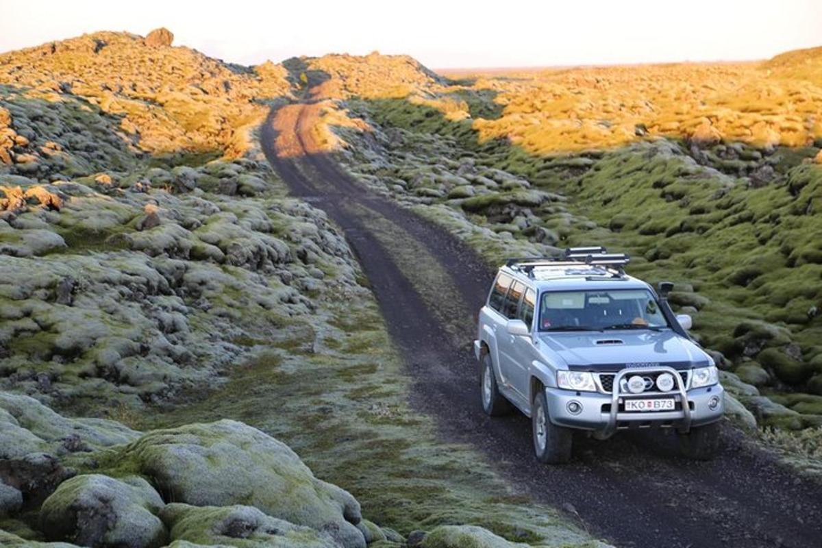a truck driving on a dirt road in the desert