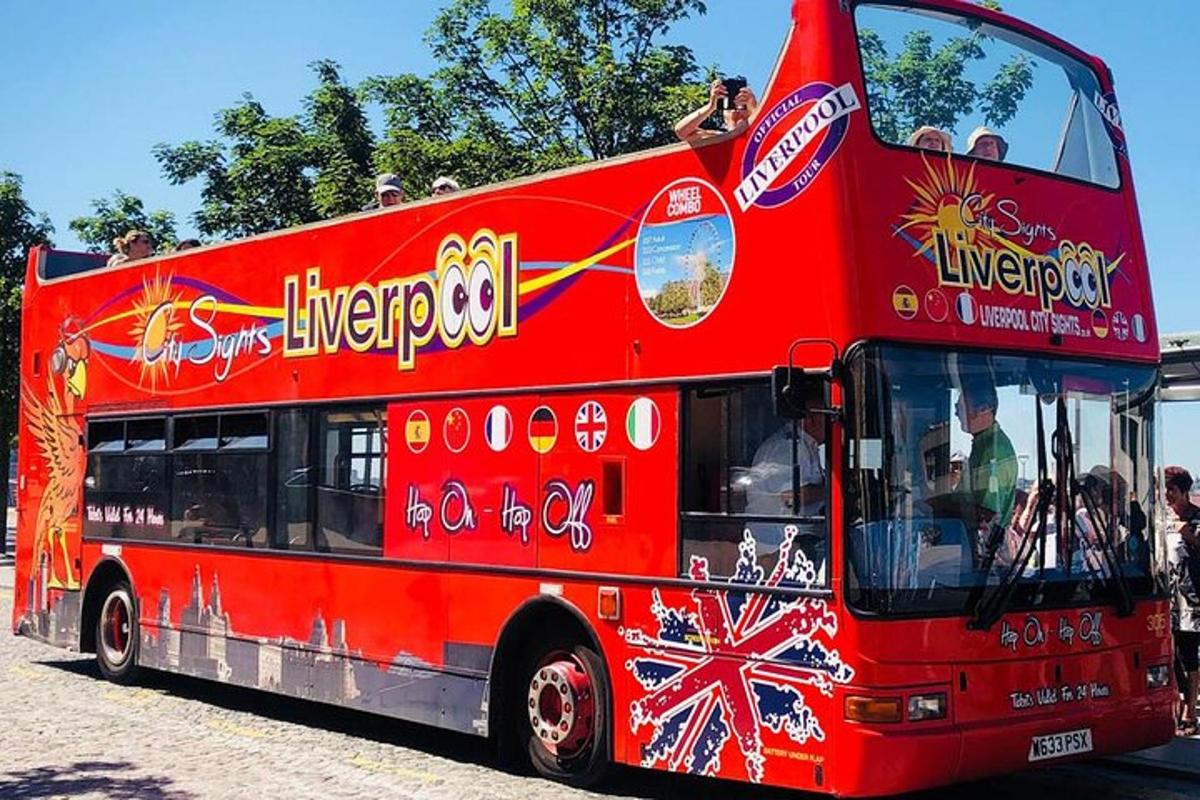 a red double decker bus driving down a street