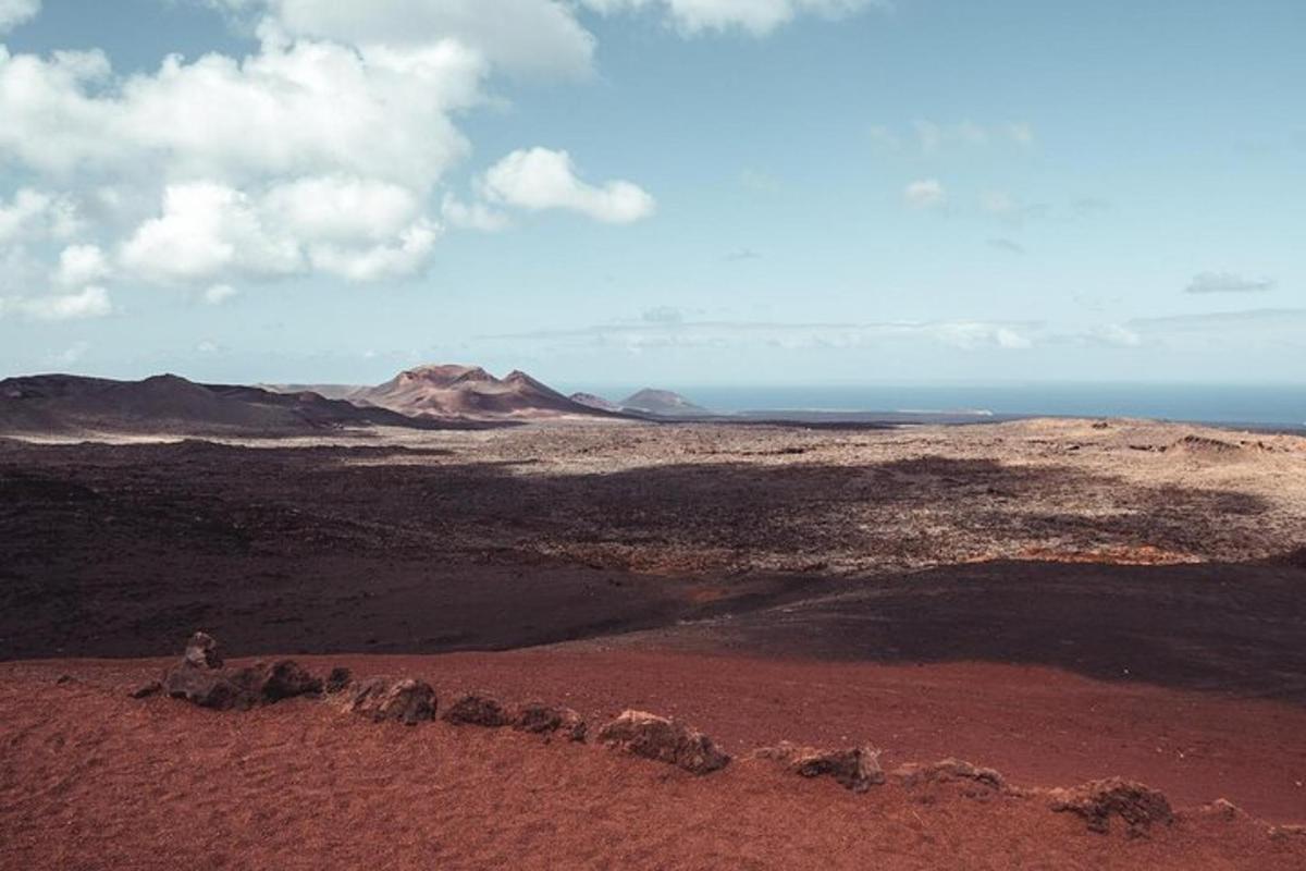 a view of a desert with mountains and the ocean