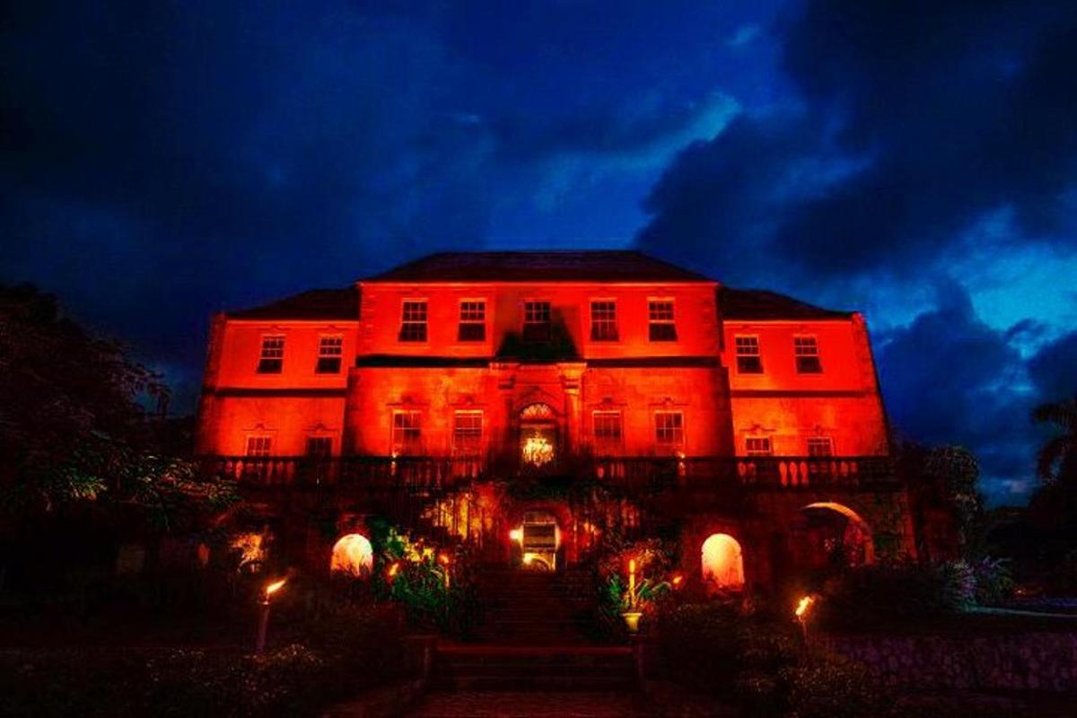 a large building with red lights on it at night