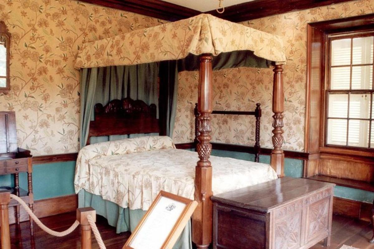 a bedroom with a canopy bed and a table
