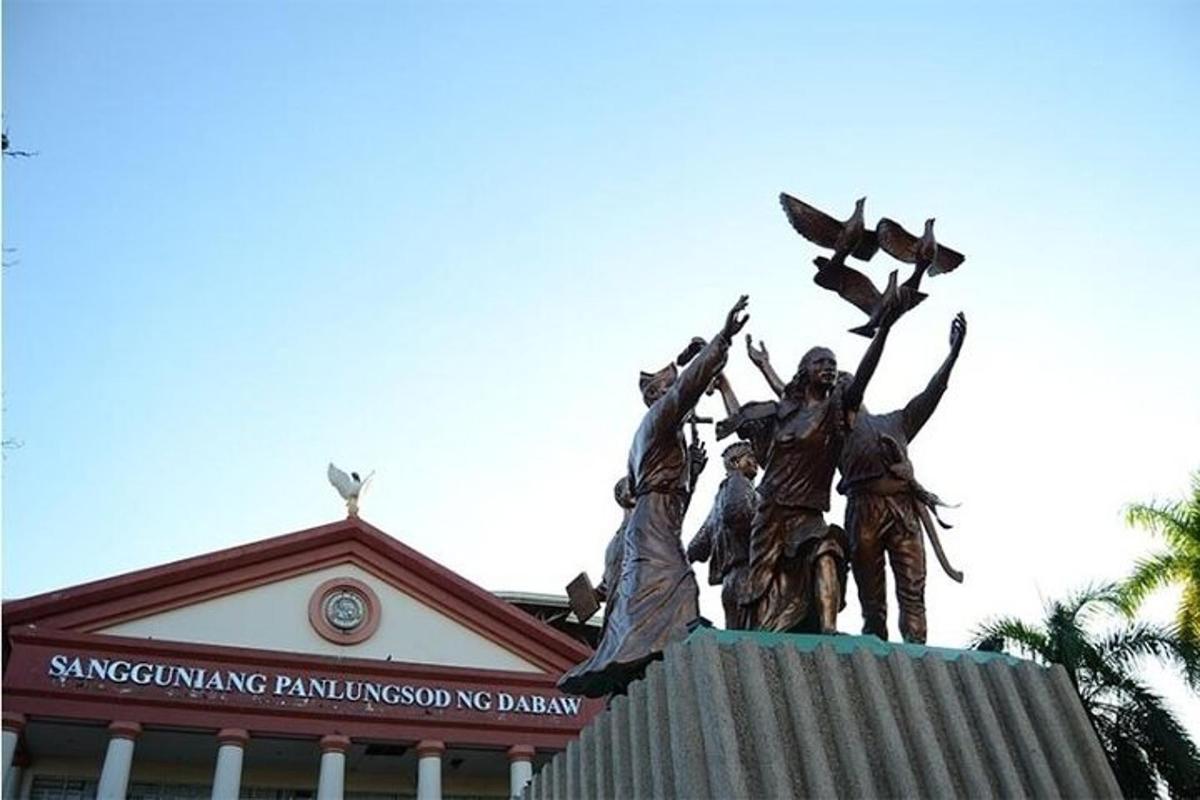 a statue of people on top of a building