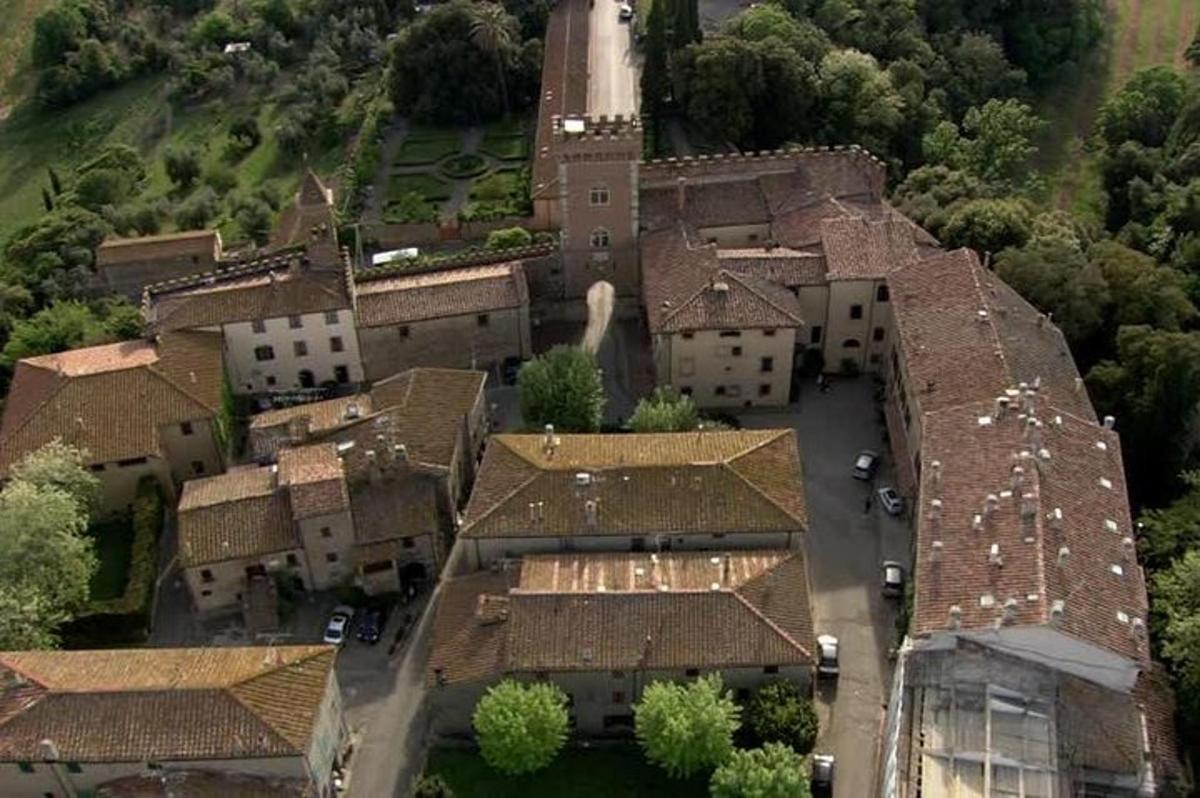 an aerial view of a large house with roofs