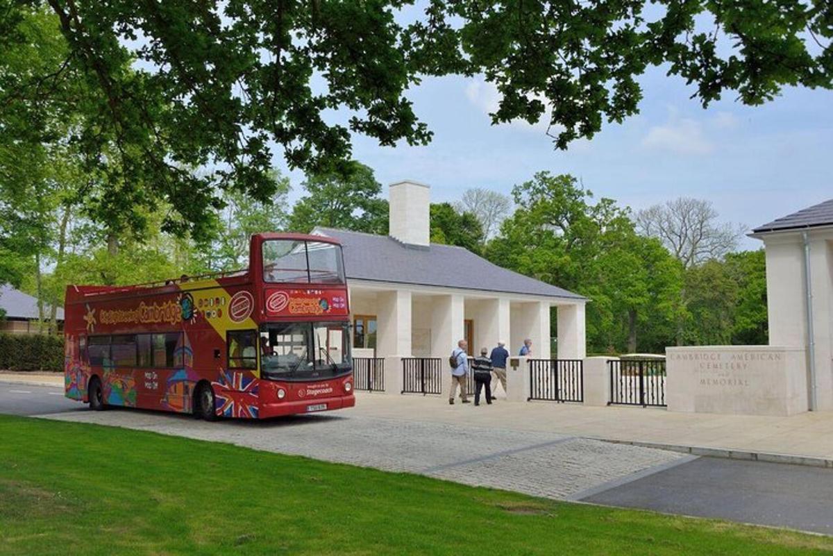 a red double decker bus parked in front of a building