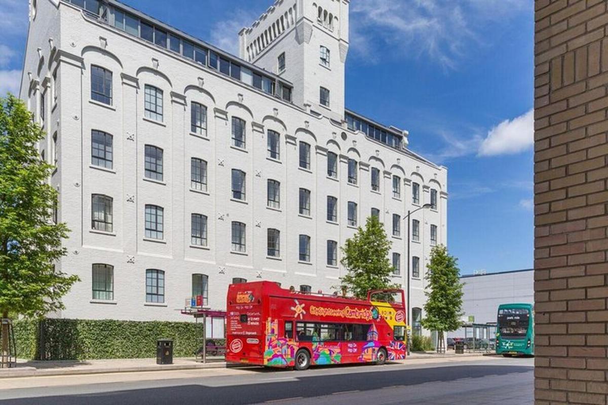 a red double decker bus parked in front of a building