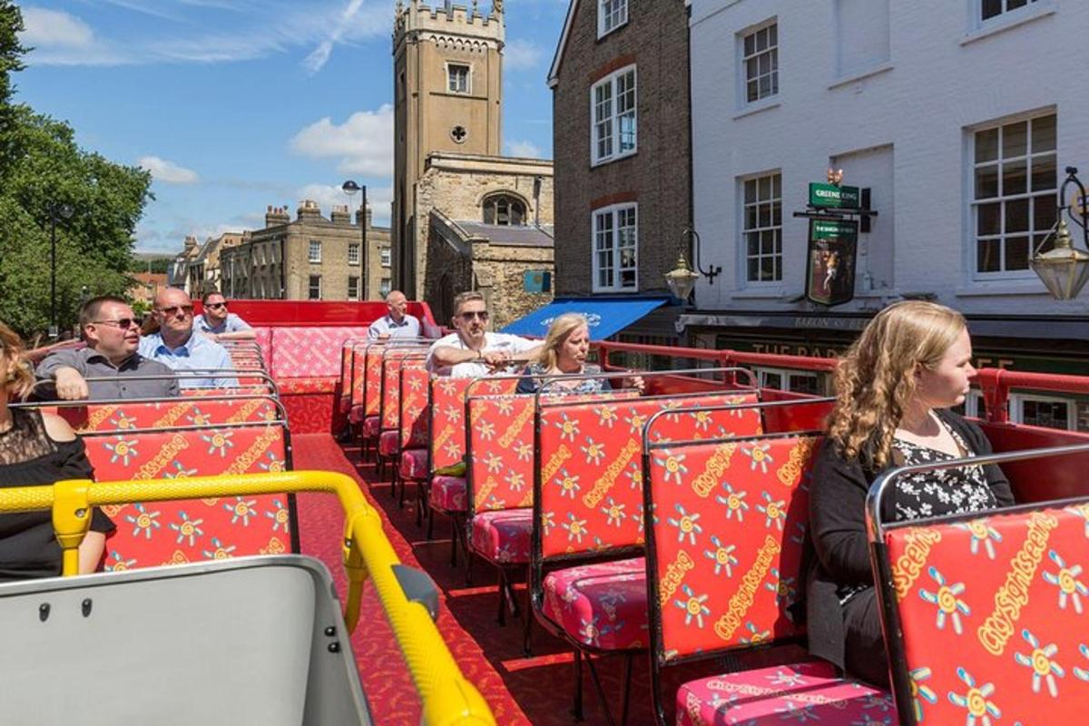 a group of people sitting on a tram in a city