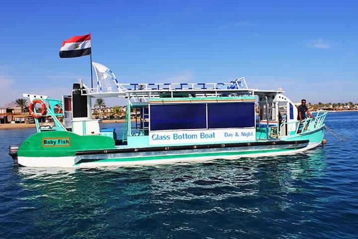 a green and white boat in the water