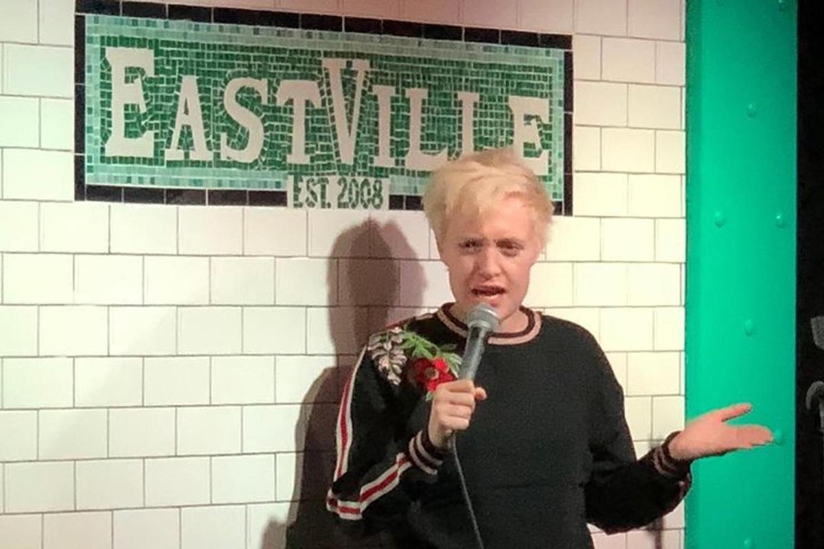 a man holding a microphone in front of a wall