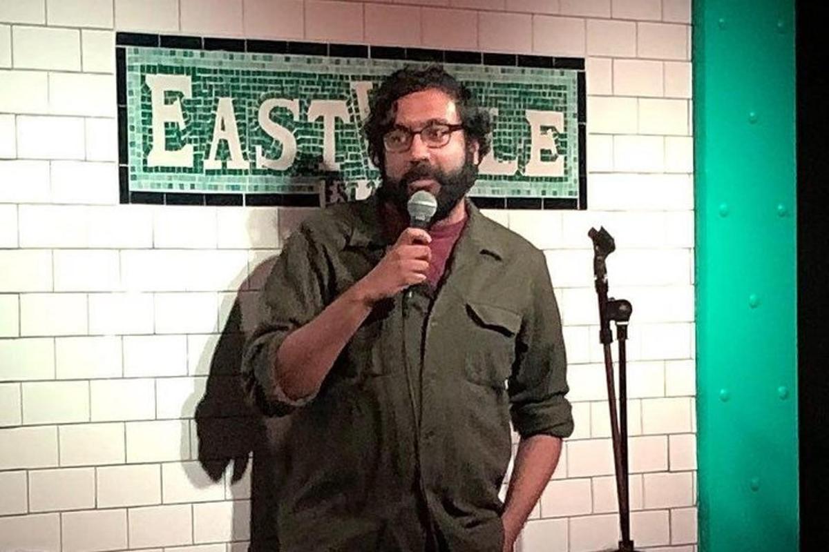 a man holding a microphone in front of a wall