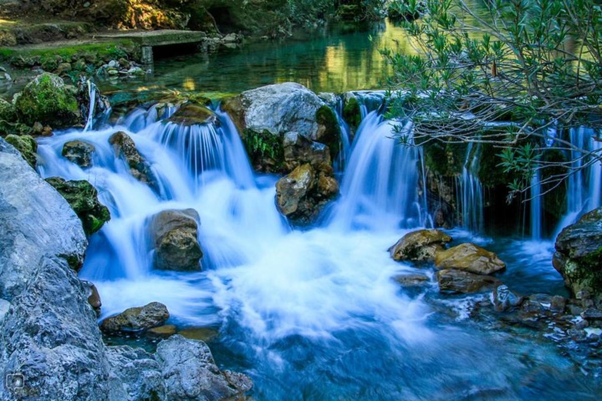 a group of waterfalls in a river with rocks