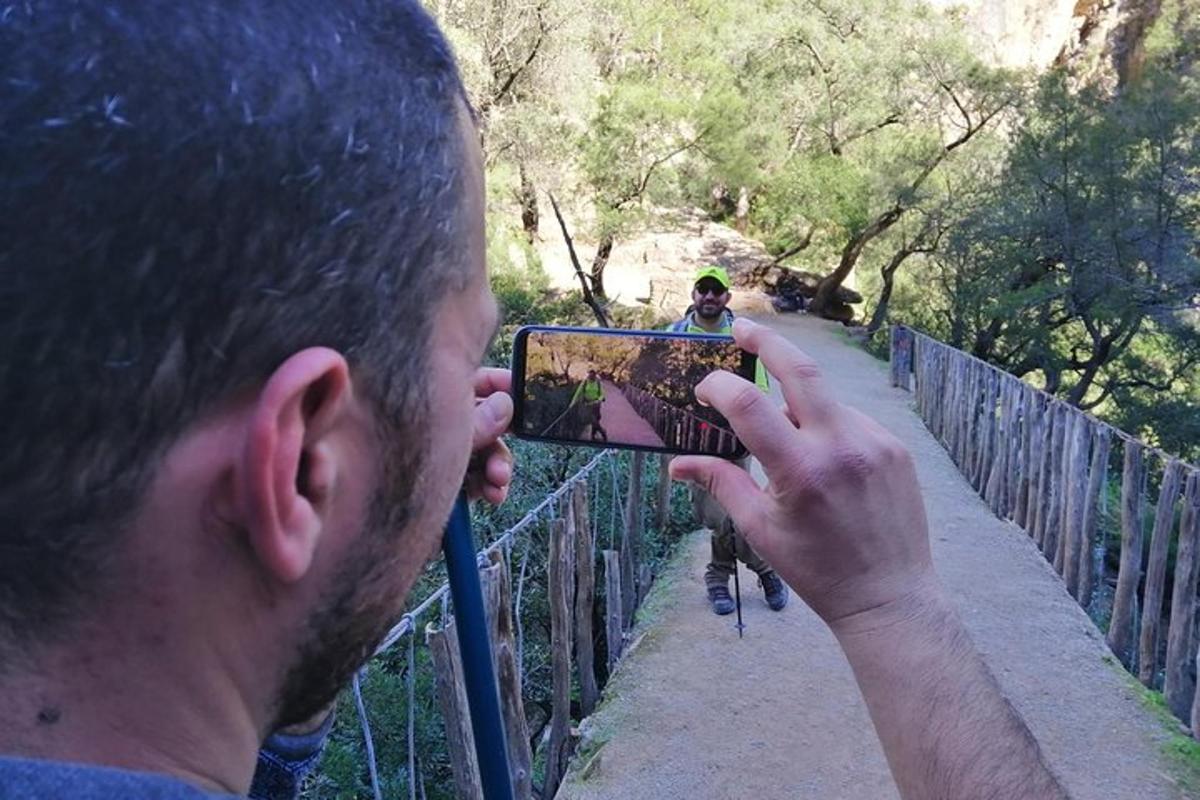 a man taking a picture of a person on a bike