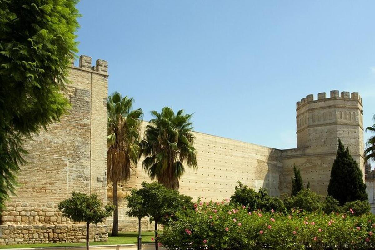 a large brick building with palm trees in front of it