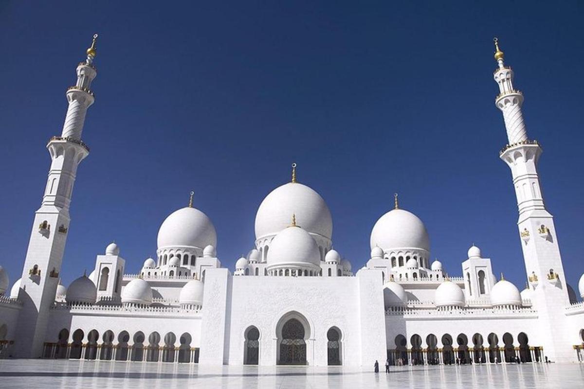 a large white mosque with domes on top of it