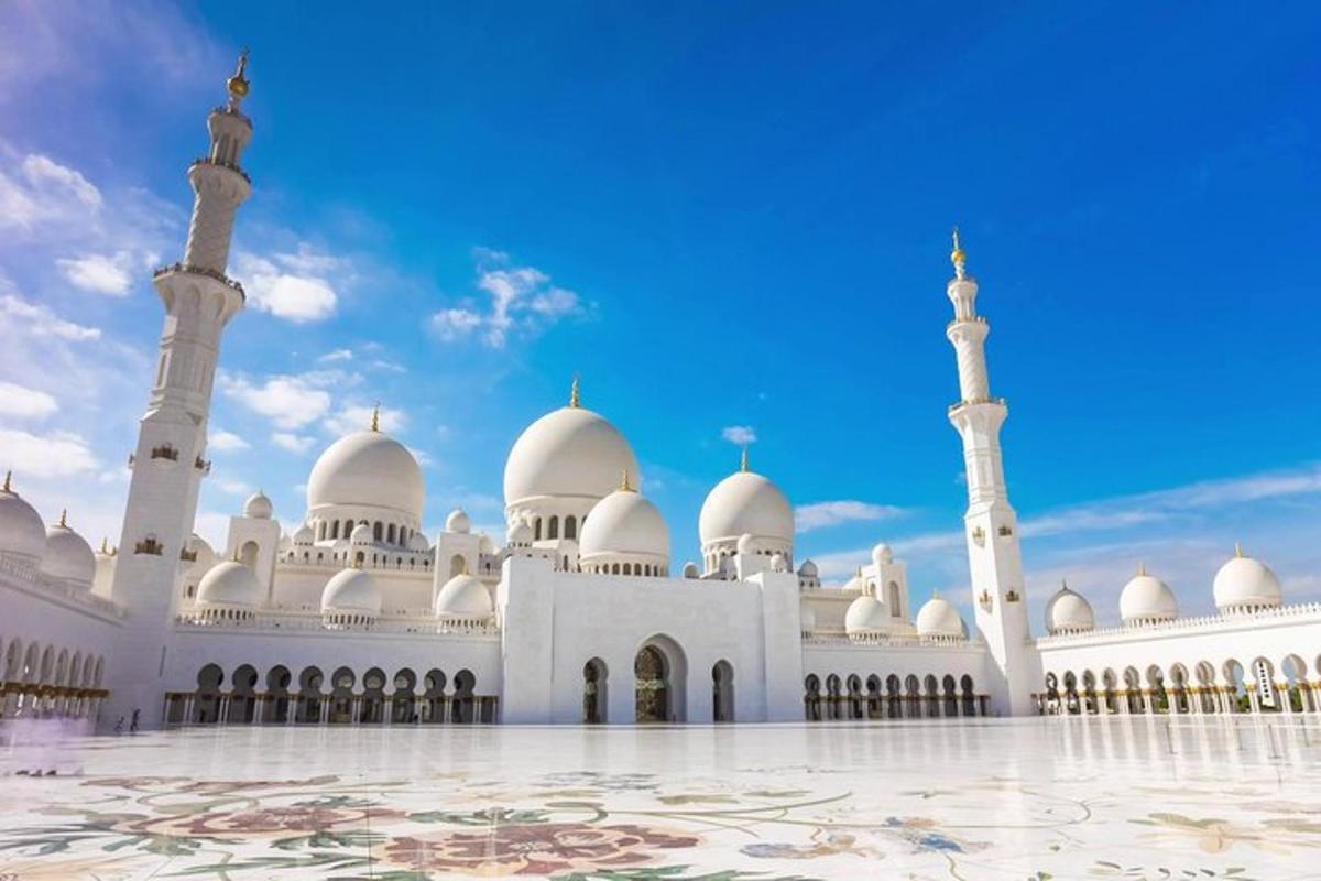 a large mosque with white domes and minarets