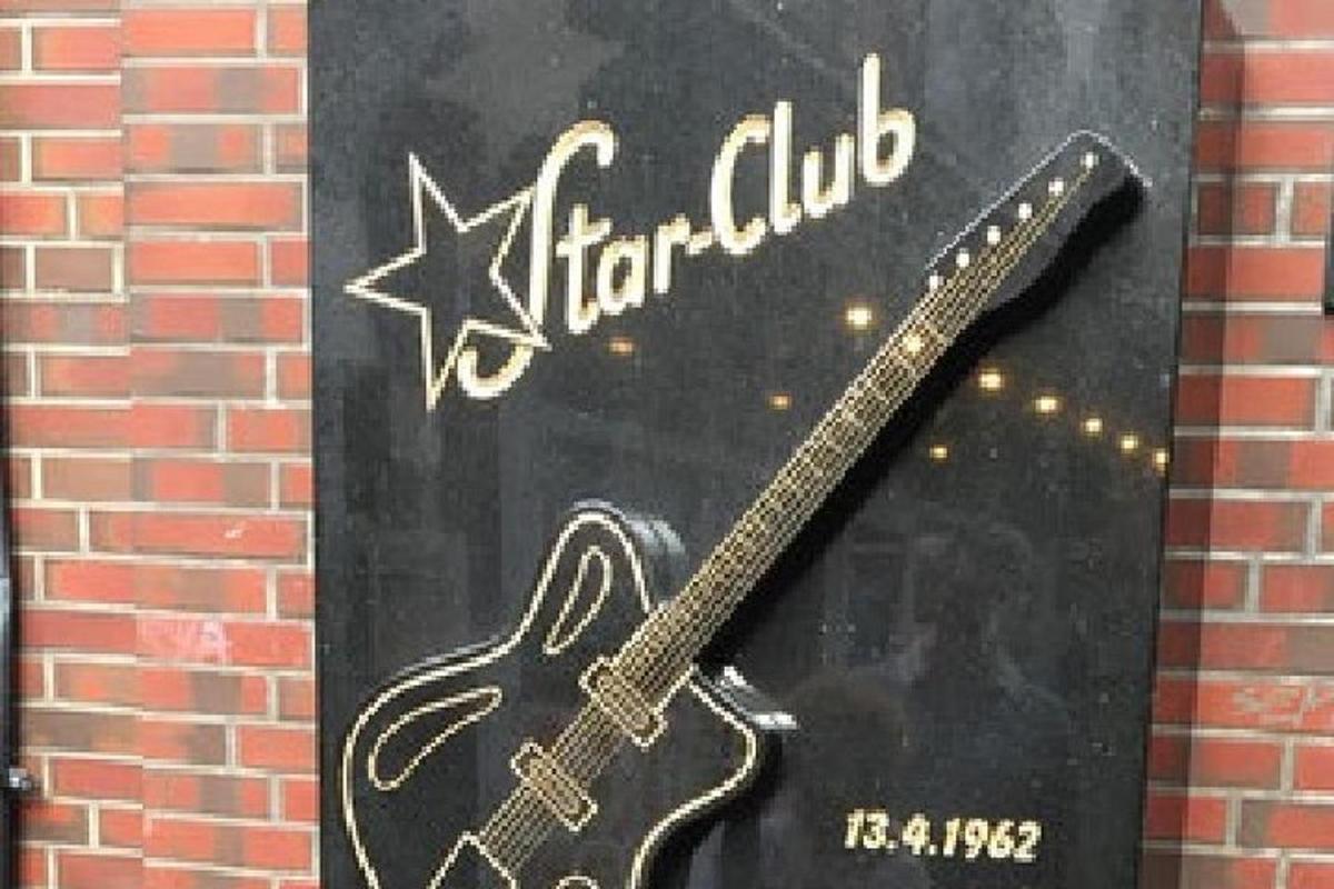 a picture of a guitar on the side of a building