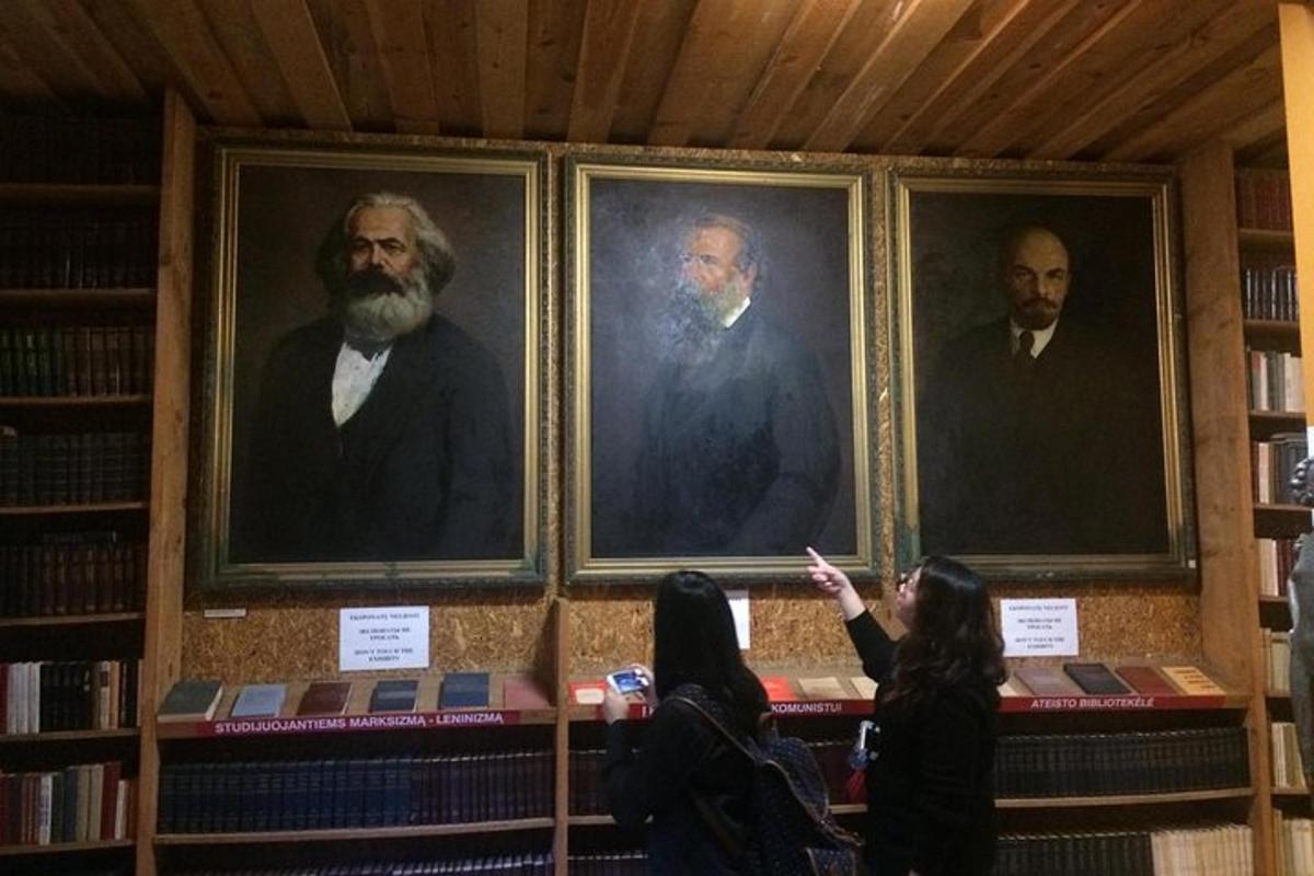 a group of people standing in front of framed portraits