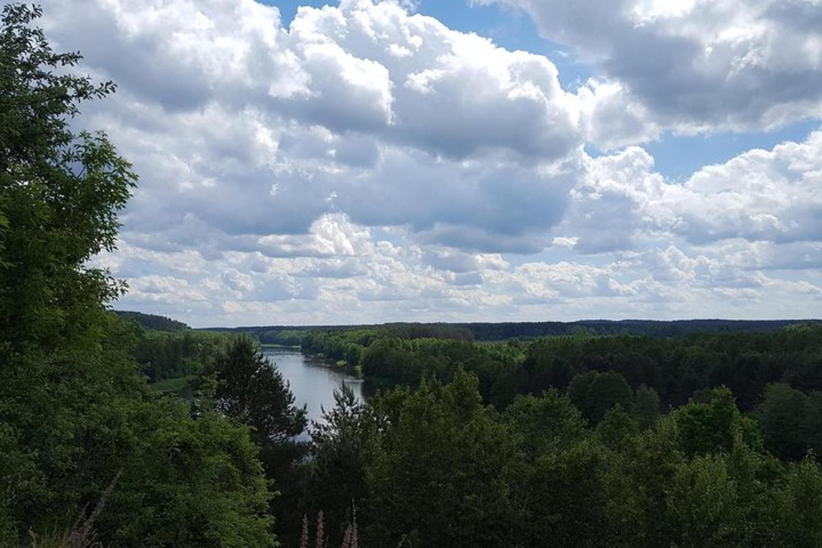 a view of a river with trees and clouds