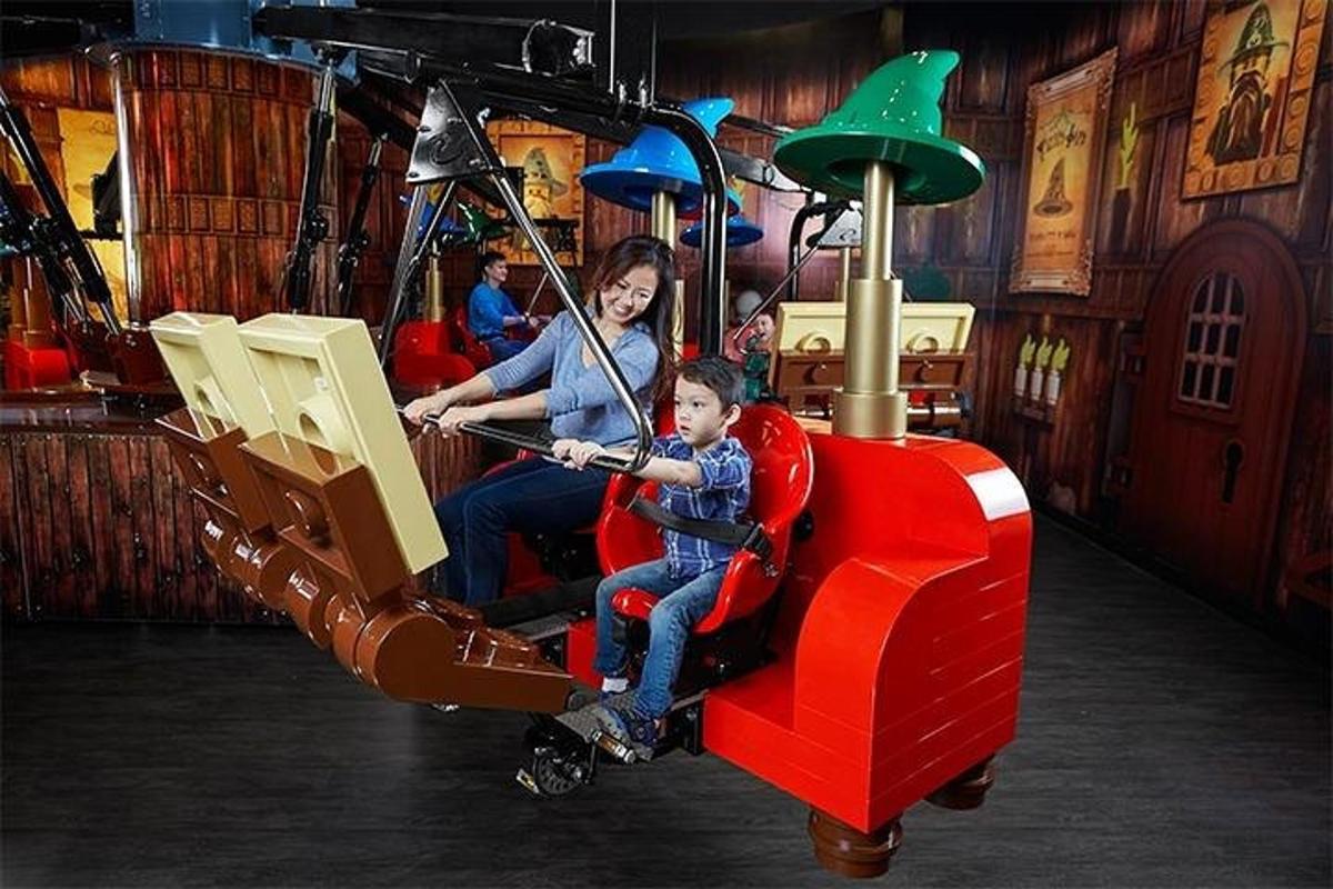 a woman and a boy riding on a roller coaster