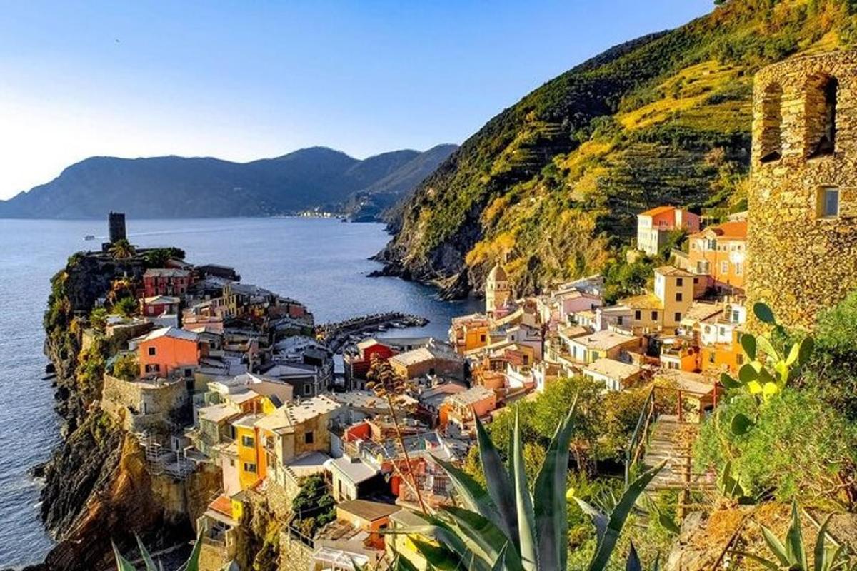 a village on the side of a hill next to the water